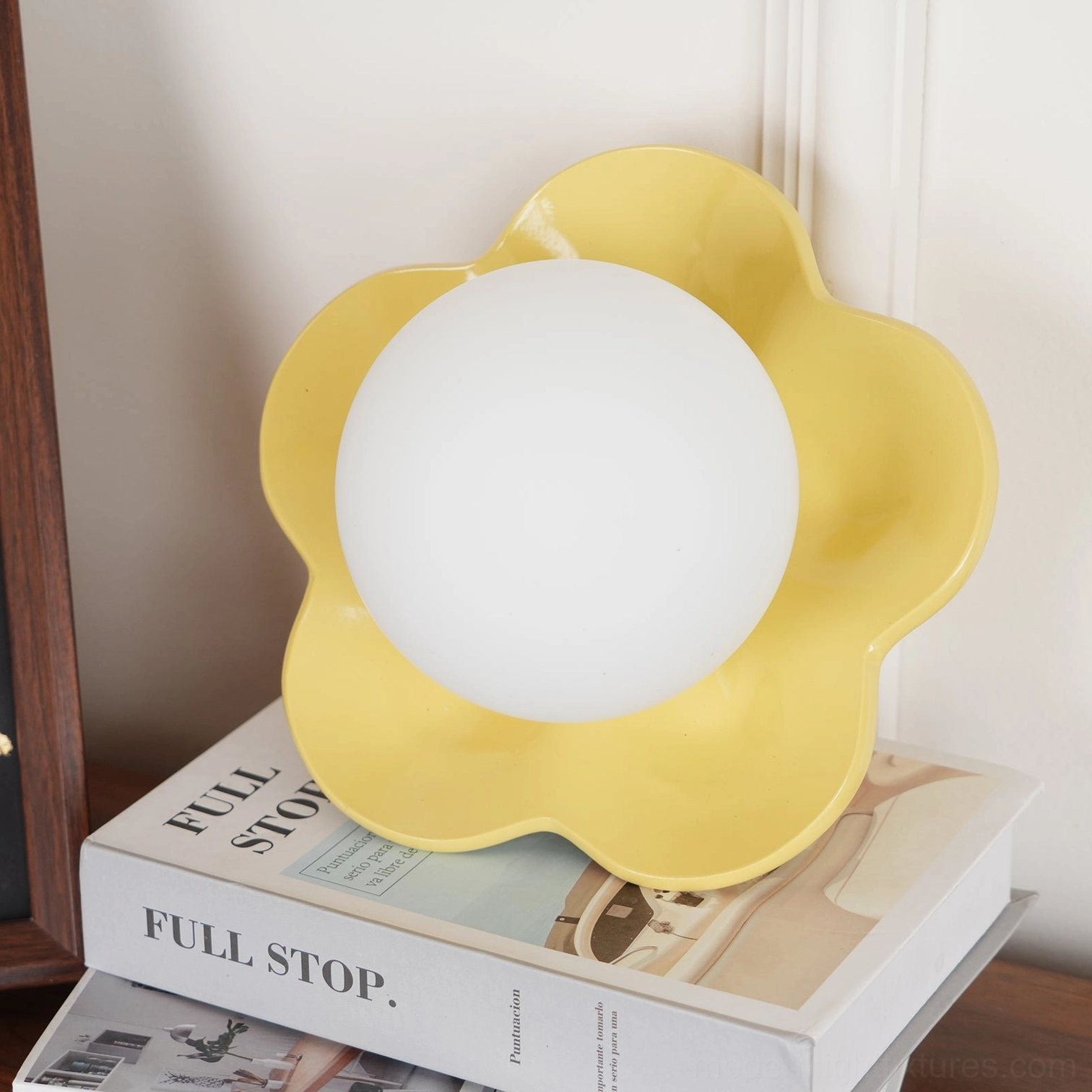 Pink flower wall lamp paired symmetrically flanking decorative mirror in vanity area