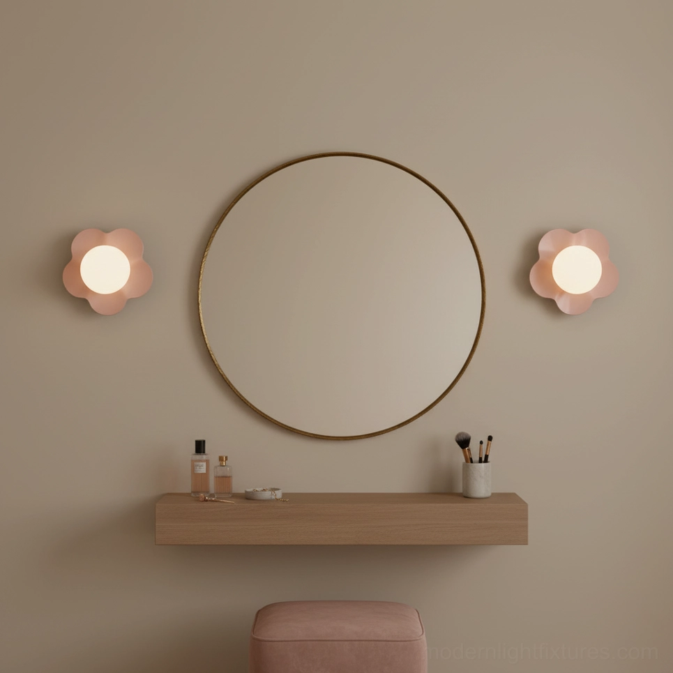 Pair of pink flower wall sconces flanking round mirror in bedroom vanity setting