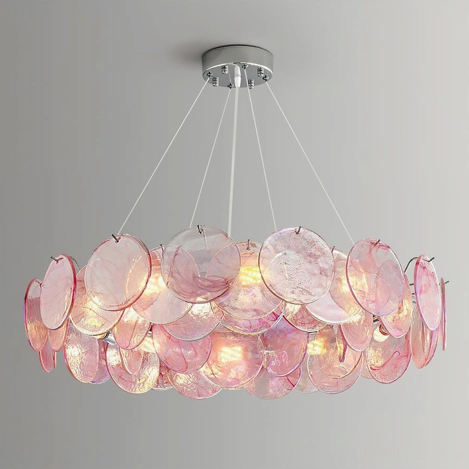 Modern pink glass chandelier three-quarter overhead view illuminated showing warm interior glow and white hanging suspension
