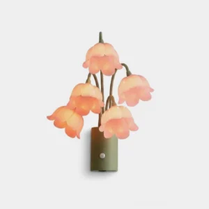 Pink lily-of-the-valley motion-sensor wall sconce with five drooping bell-flower acrylic shades on green iron stems, studio front view