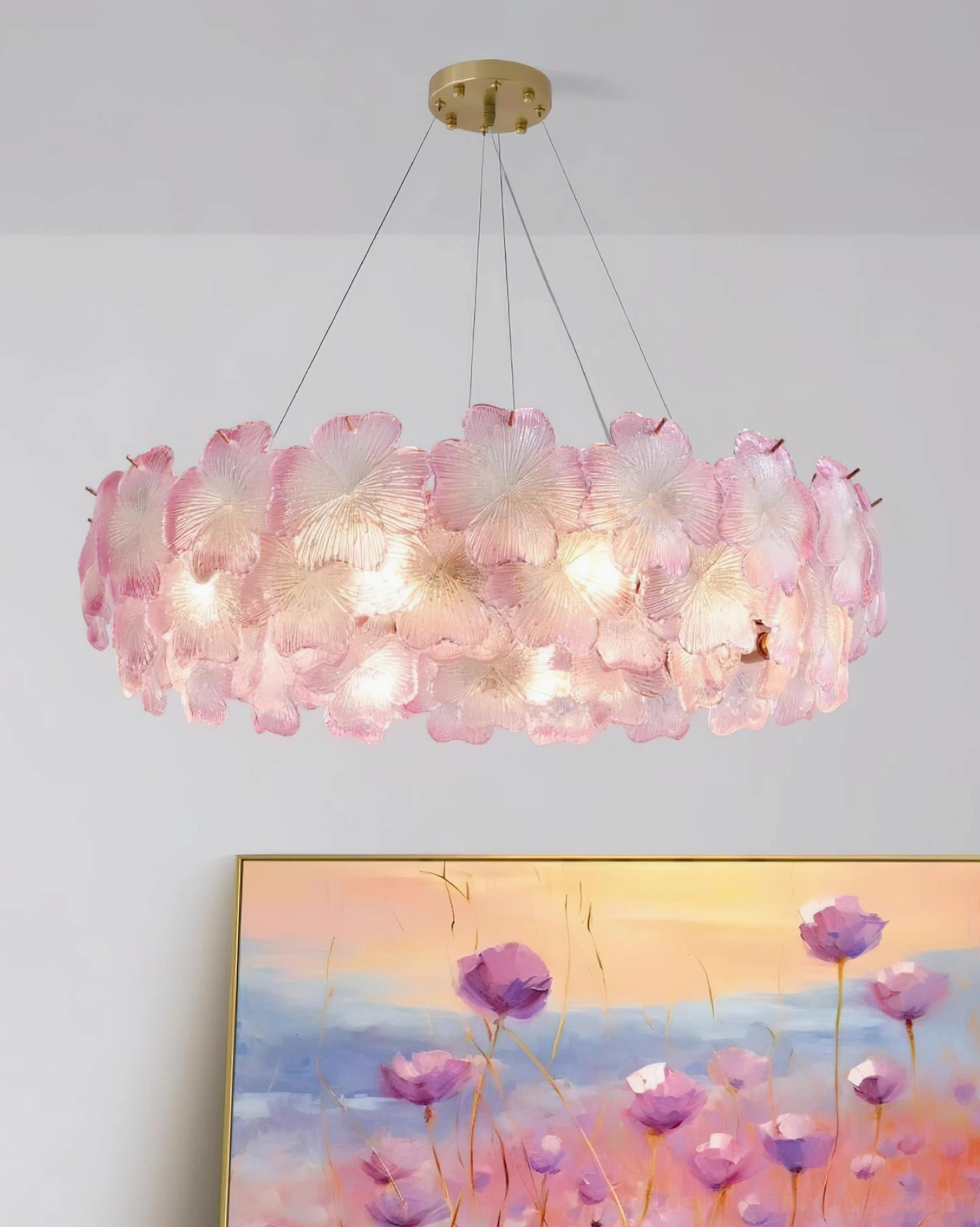 Large pink Mika flower chandelier with tiered petal design and warm lighting in decorated home