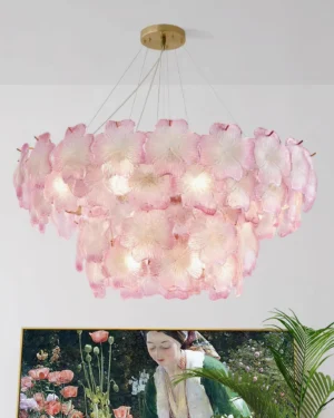 Pink Mika botanical chandelier illuminated in modern living room with warm ambient lighting and green plant decor