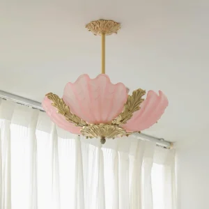 Pink frosted Murano shell pendant light installed indoors, upward view showing antique brass hardware and sheer curtains