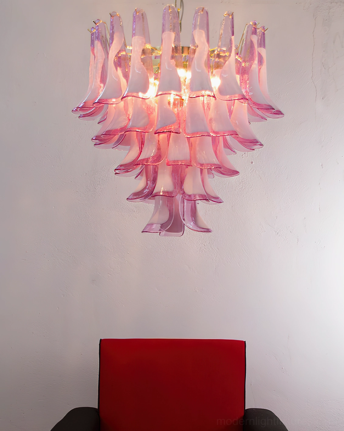Pink gradient Murano glass tulip chandelier installed in living room with red accent chair, romantic luxury modern pendant light fixture