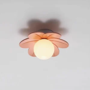 Blush pink resin petal ceiling fixture with glowing frosted glass diffuser and overhead shadow detail