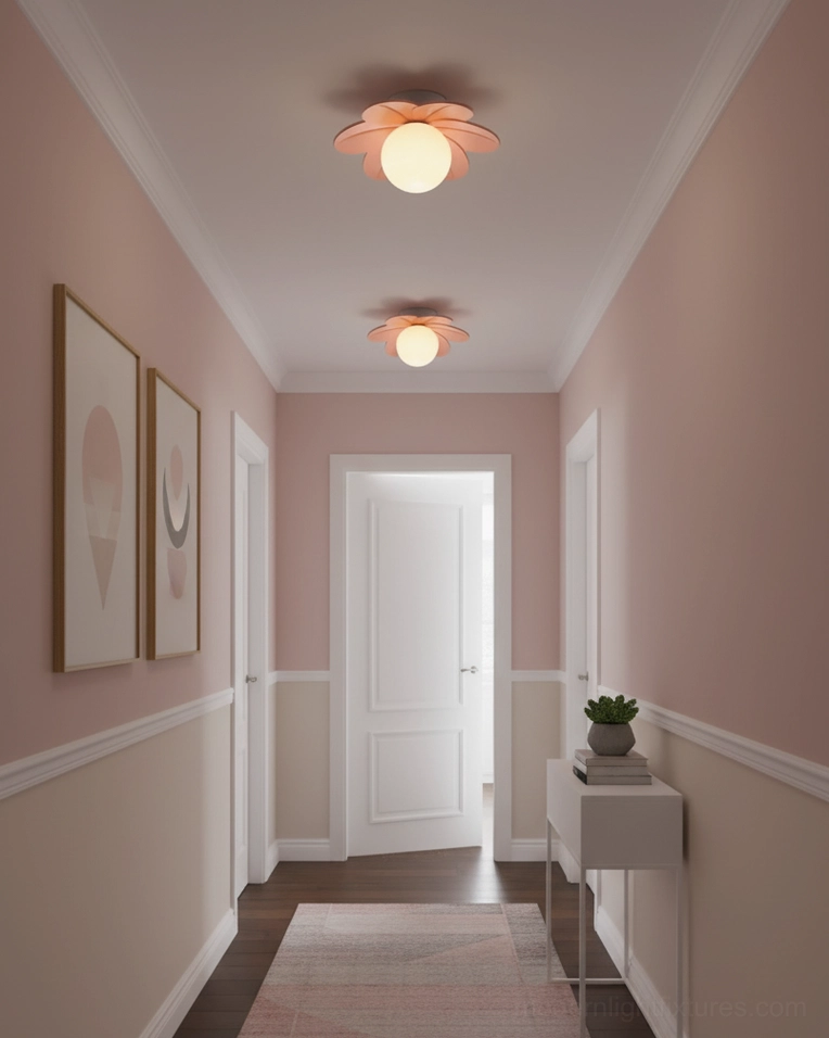 Pink petal ceiling light installed in pastel residential corridor with matching pink-toned walls and minimalist art