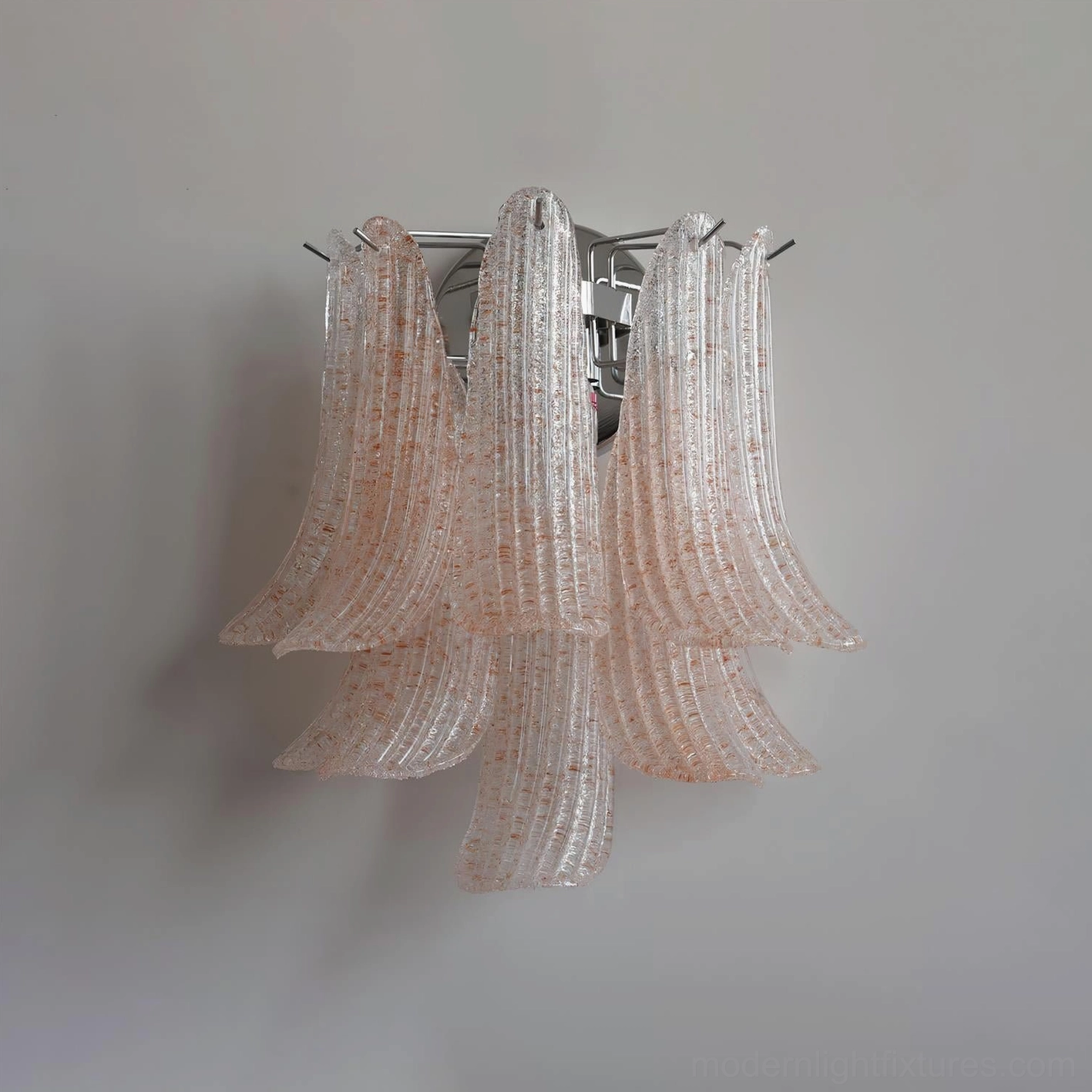 Three-quarter angle view of pink textured petal glass wall sconce against gray background, showcasing dimensional form