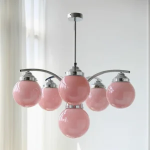Pink Salamanca pendant chandelier with frosted glass globes, 6-head configuration, indoor living room setting with natural daylight