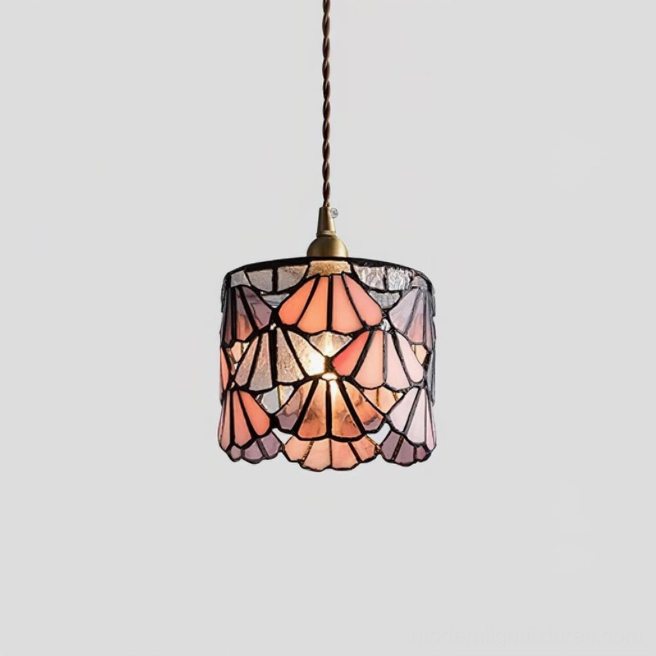 Pink stained glass pendant lamp creating romantic warm ambient light in bedroom interior
