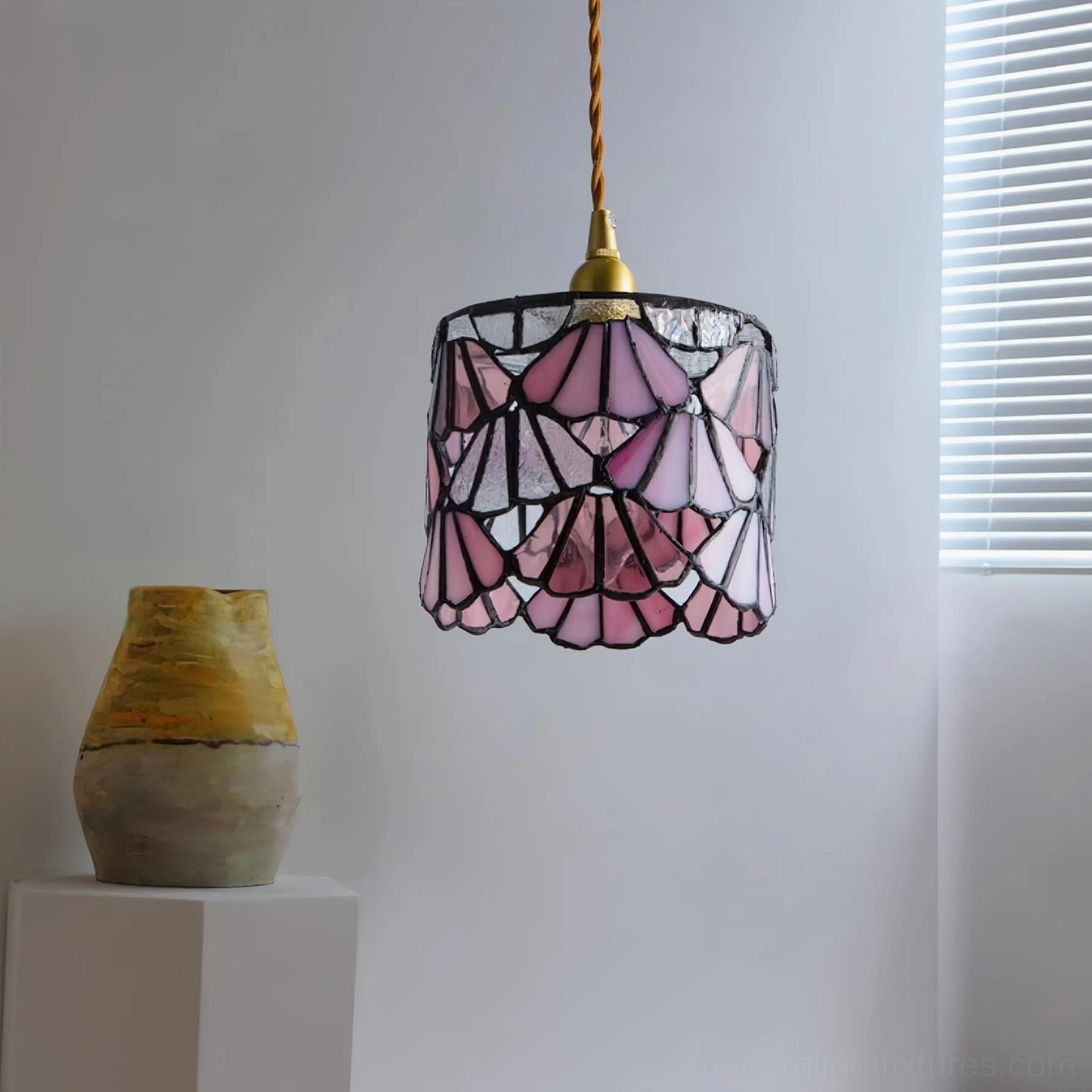 Pink stained glass pendant light close-up showing lead line detail and glass color saturation