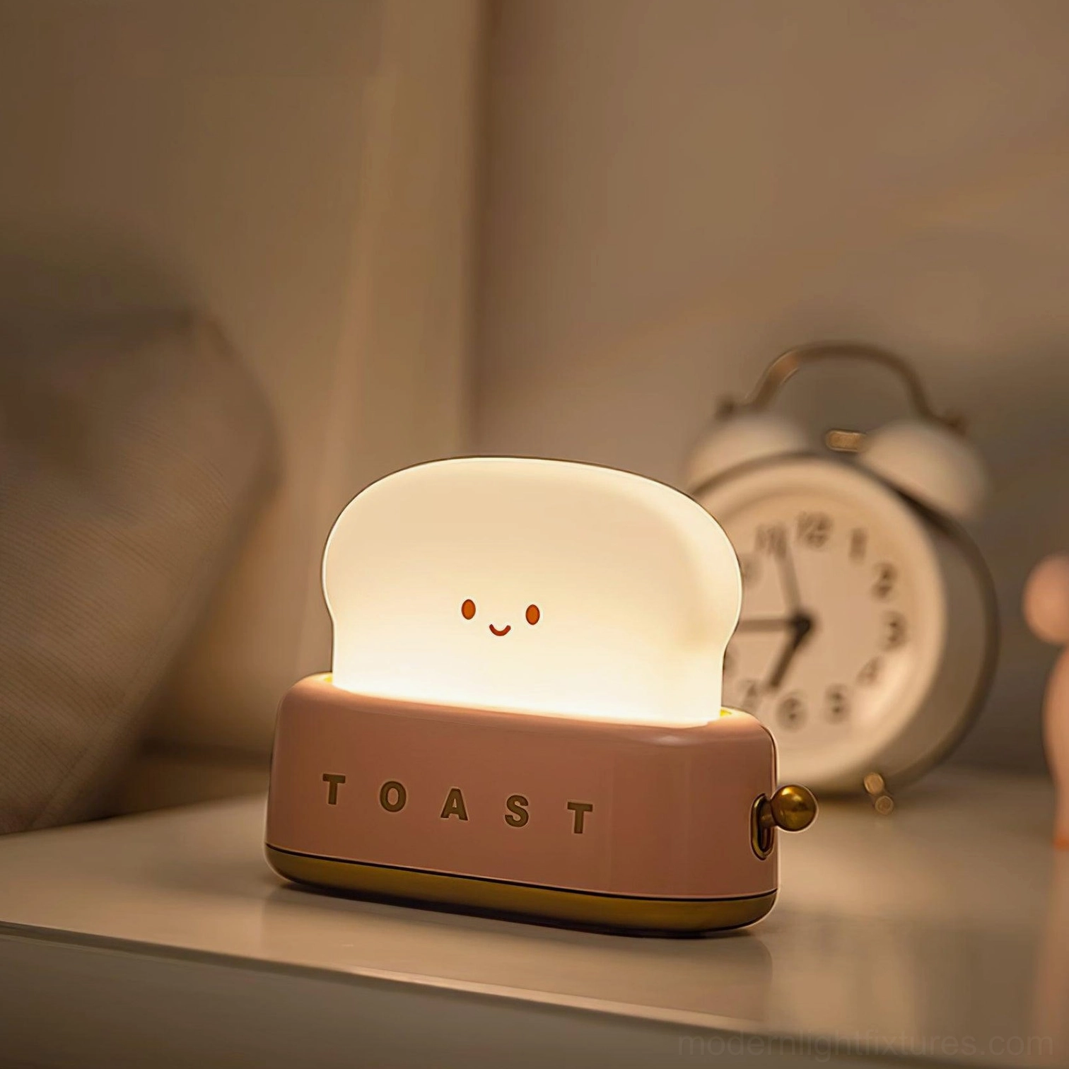Pink retro toaster table lamp on bedroom nightstand with alarm clock and warm ambient light