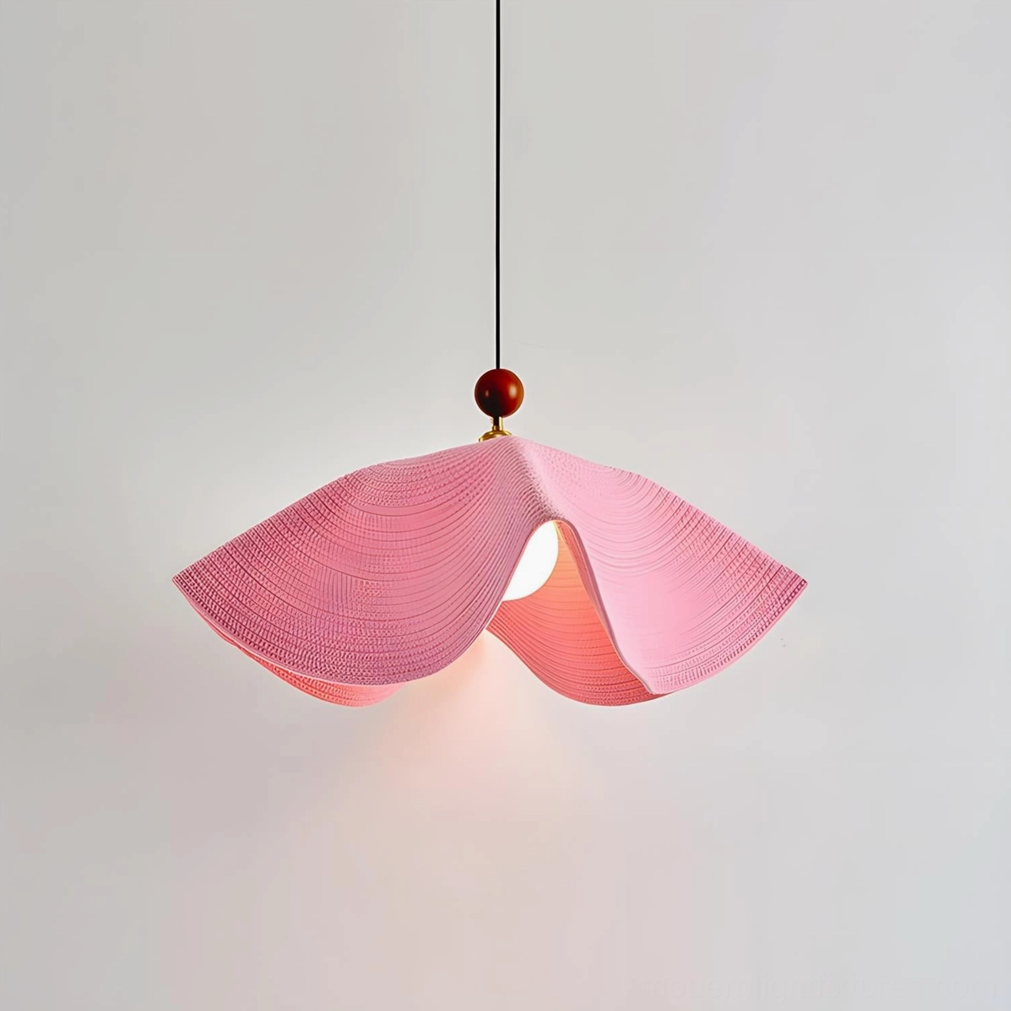 Soft pink wave pendant light creating warm ambiance in transitional dining space
