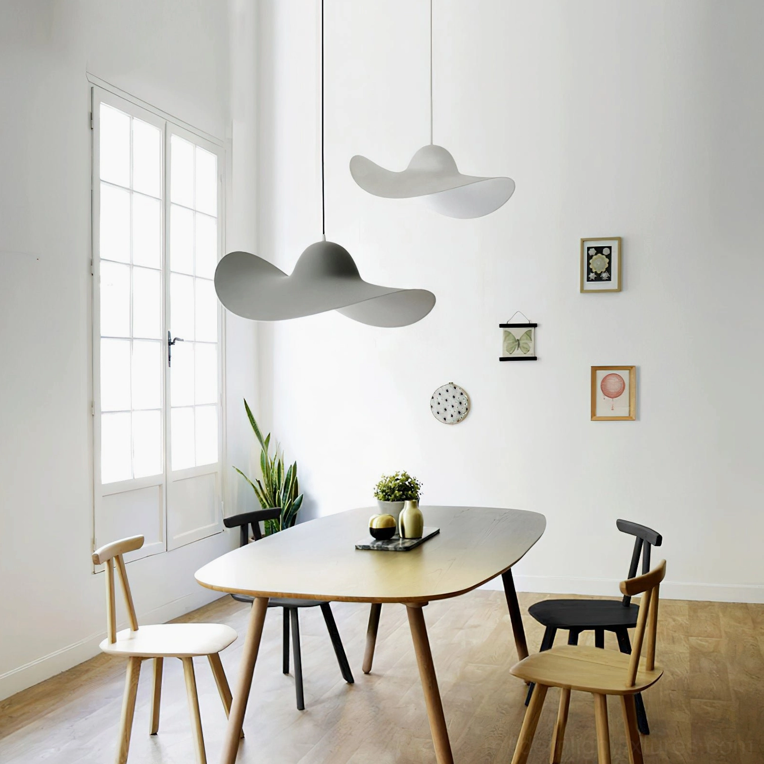 Piuma modern pendant lights in Nordic dining room - gray and white matte resin fixtures with minimalist decor