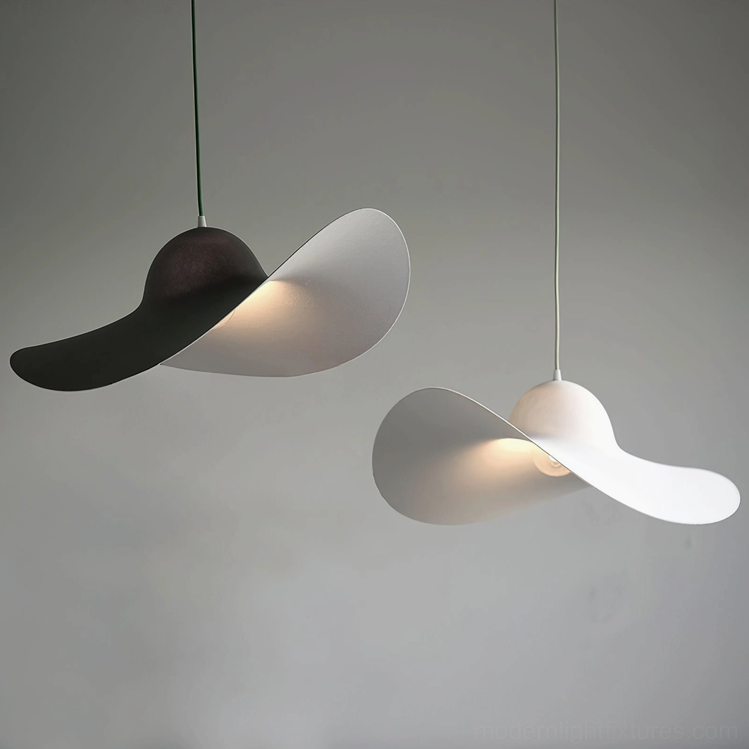 Piuma sculptural pendant light fixtures - white and dark gray matte resin design showing minimalist aesthetic