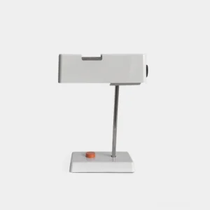 Pixelite modern table lamp with white body, polished chrome arm, and geometric base in studio lighting