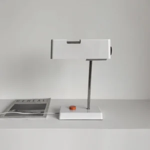 Pixelite geometric table lamp displayed on floating shelf with contemporary home decor and magazine