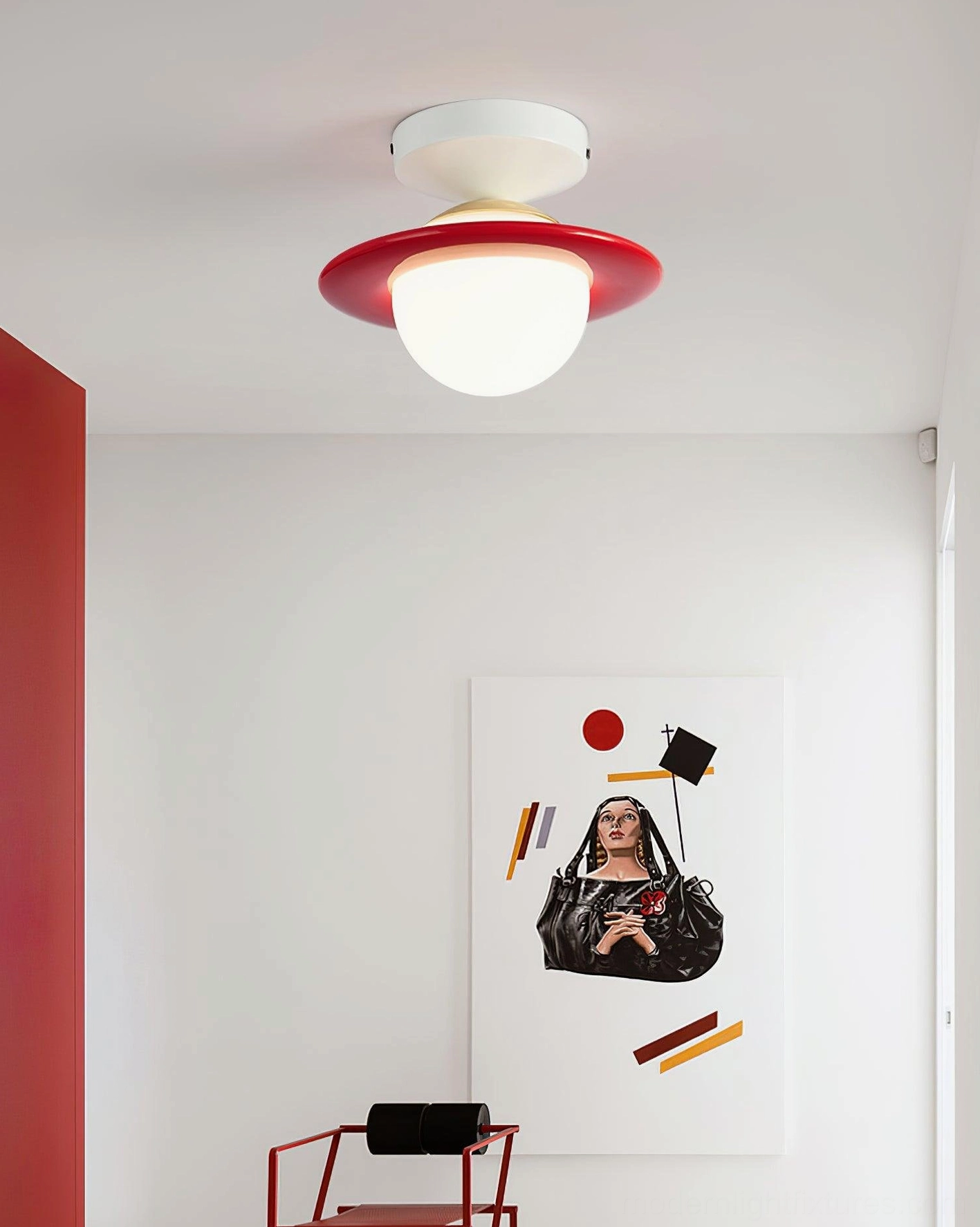 Red accent planet ceiling light mounted in contemporary bedroom with wall art and geometric design elements