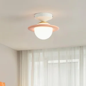 Pink trim planet ceiling light installed in minimalist Nordic living room with sheer curtains and warm ambient glow