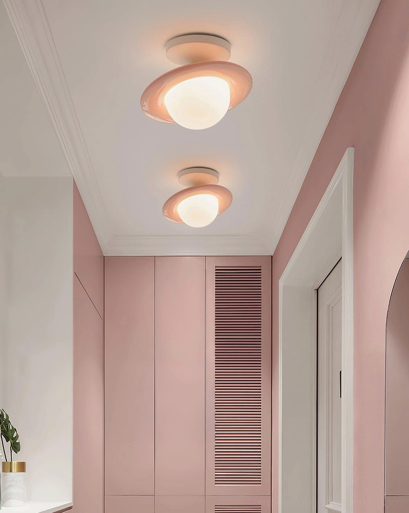 Dual planet ceiling lights with peach pink trim mounted in residential hallway overhead view