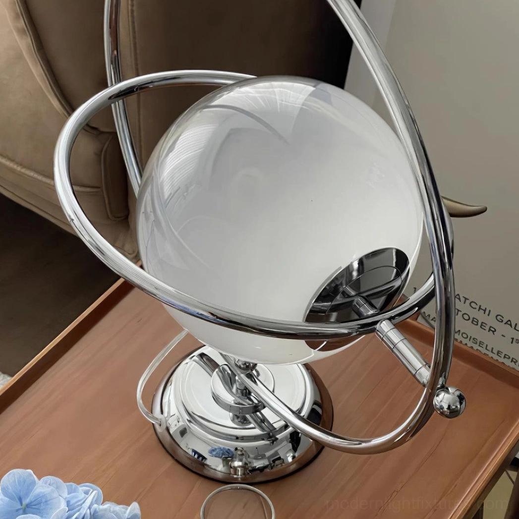Rotating planet desk lamp illuminated showing light diffusion through frosted shade
