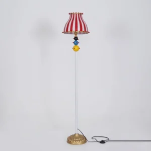 Vintage-style circus floor lamp with iconic red and white vertical stripes, pom-pom trim, colored sphere ornaments, complete product shot