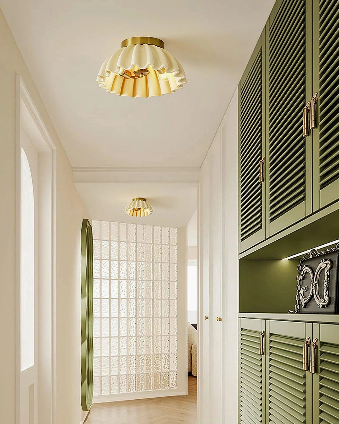 Pleated ceiling light fixture in residential hallway corridor with green cabinet accent
