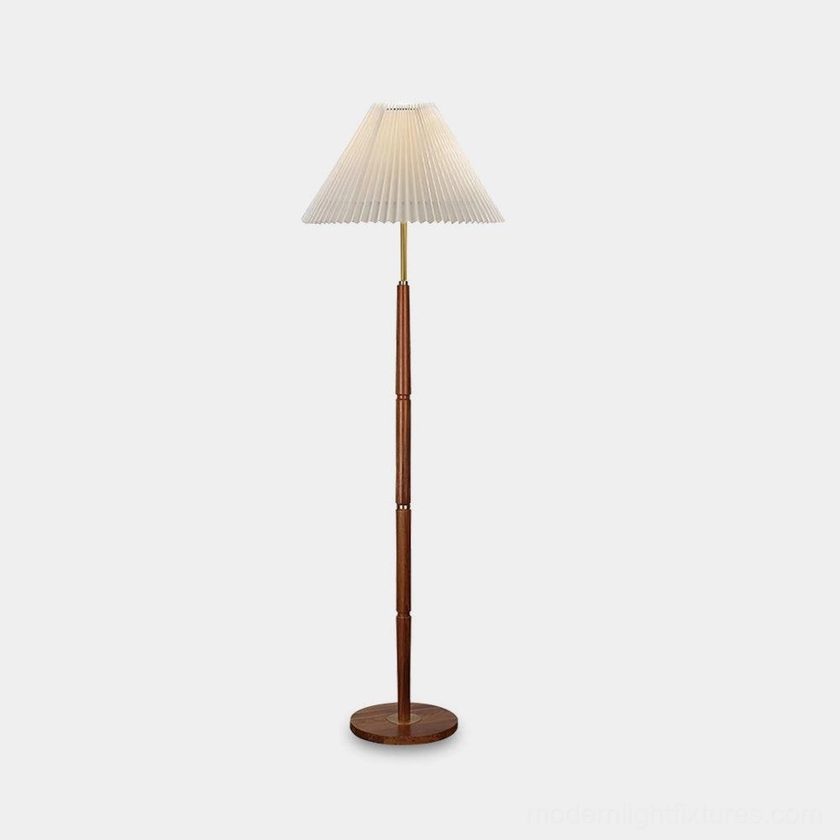 Pleated fabric floor lamp with white shade and walnut wood base on studio background – mid-century modern design