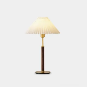 Pleated fabric table lamp with walnut wood grain finish and metal accents displayed on white studio background