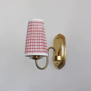 Classic European-style wall sconce with hand-pleated checkered fabric shade and polished brass finish centered product shot
