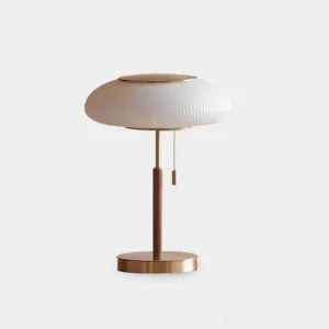 Pleated mushroom table lamp front view with milky white shade, brass base and wooden stem on plain white background - mid-century modern design
