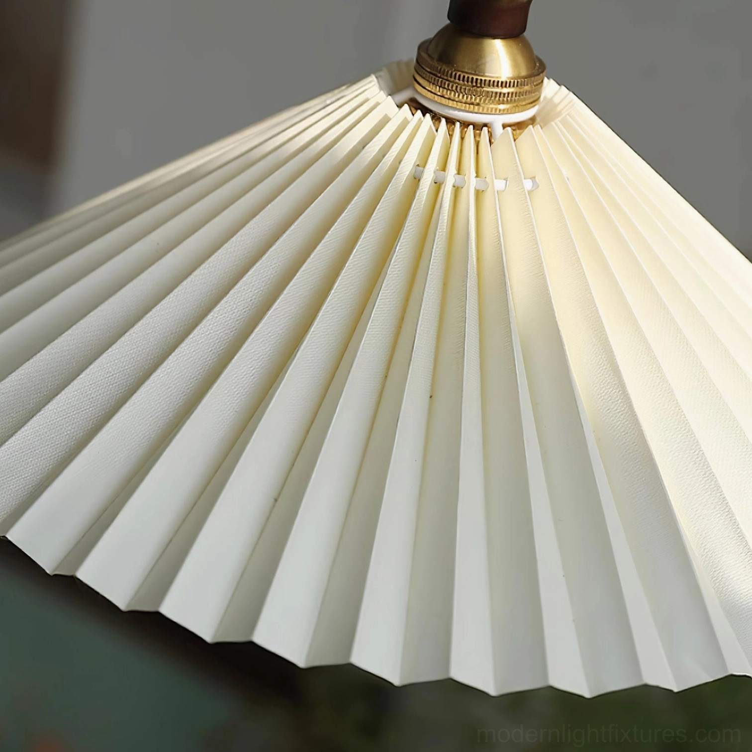 Compact pleated pendant lamp with white fabric shade and walnut frame - bedside installation view