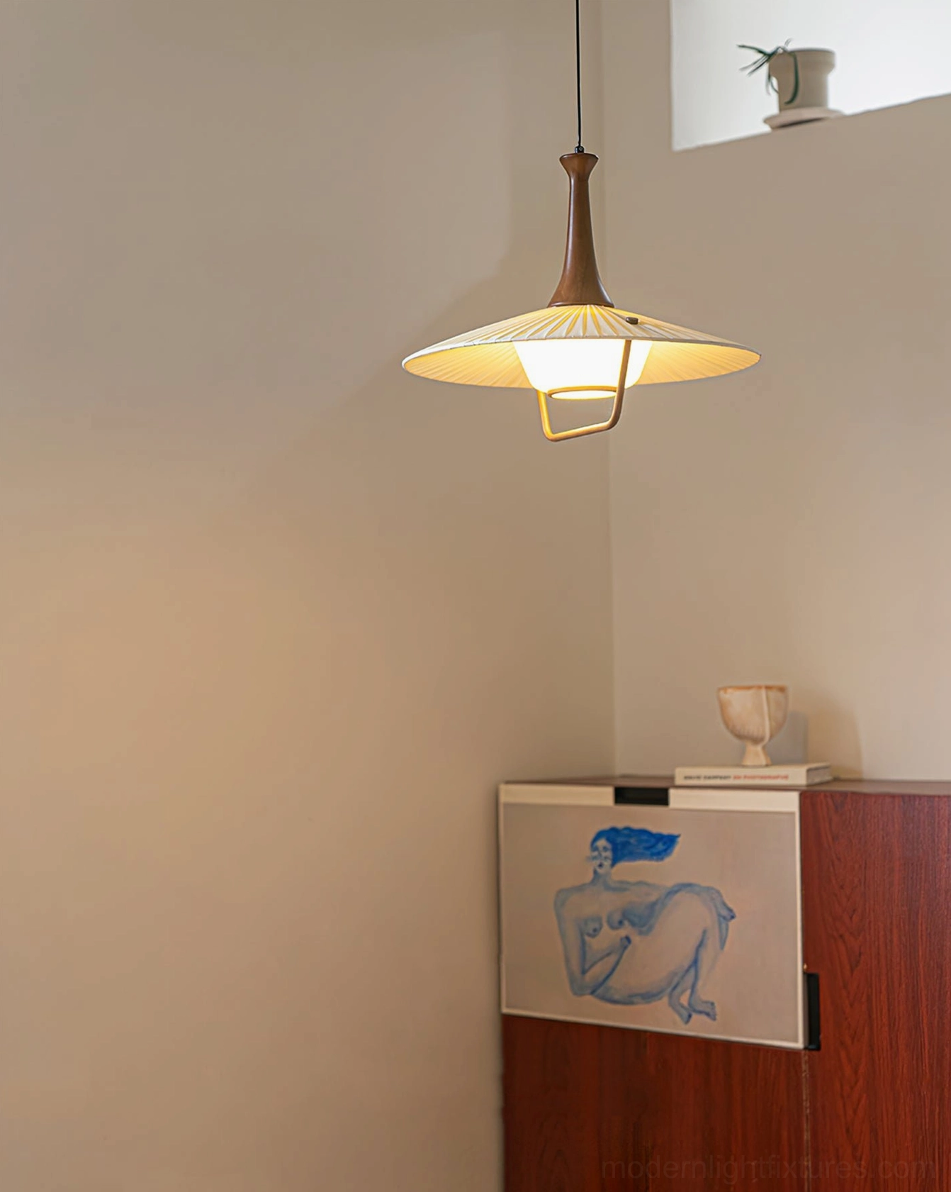 Contemporary pleated pendant lamp installation above kitchen counter modern interior design