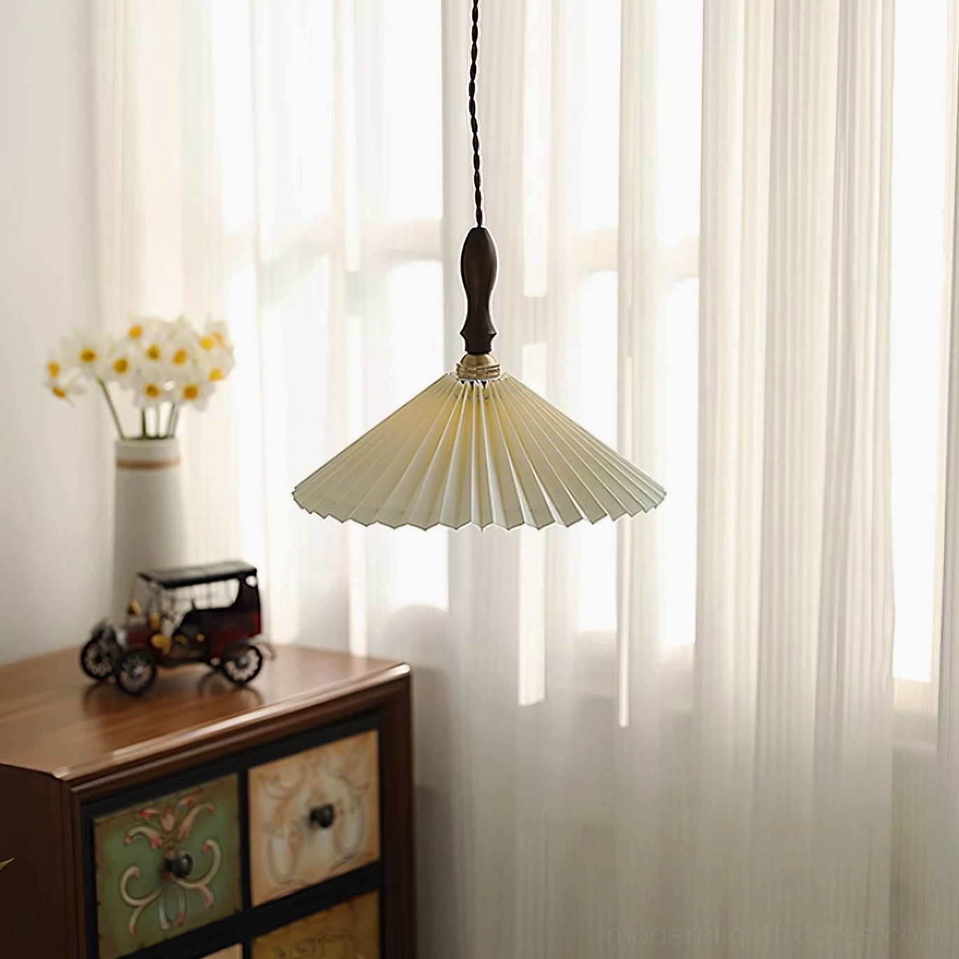 Pleated pendant lamp in contemporary bedroom setting with warm ambiance and minimalist styling