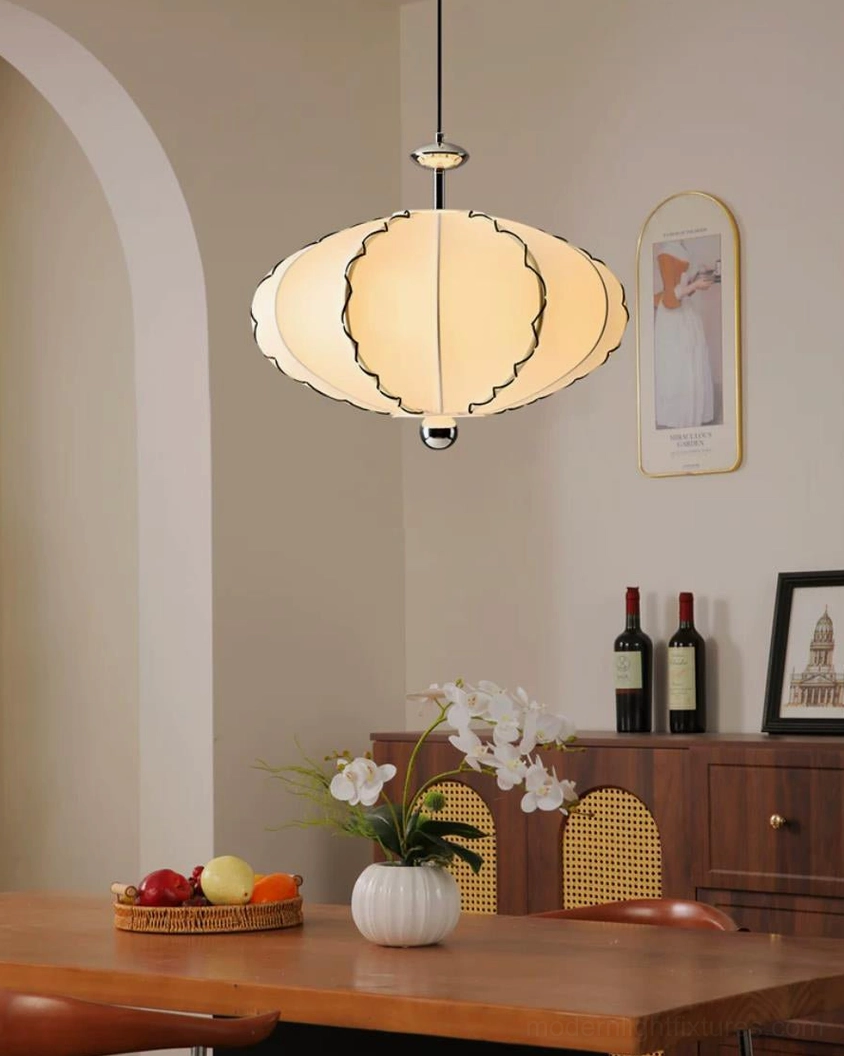 Cream pleated fabric pendant light with warm diffused glow in modern farmhouse dining setting with natural wood and warm tones