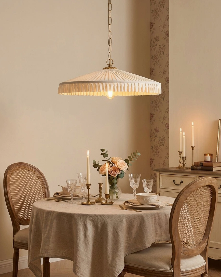 Pleated pendant light in formal dining room with linen tablecloth and candle decor, low angle view