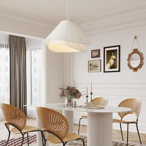 Modern pleated pendant light installed in French-style dining room with warm ambient lighting and wall decor