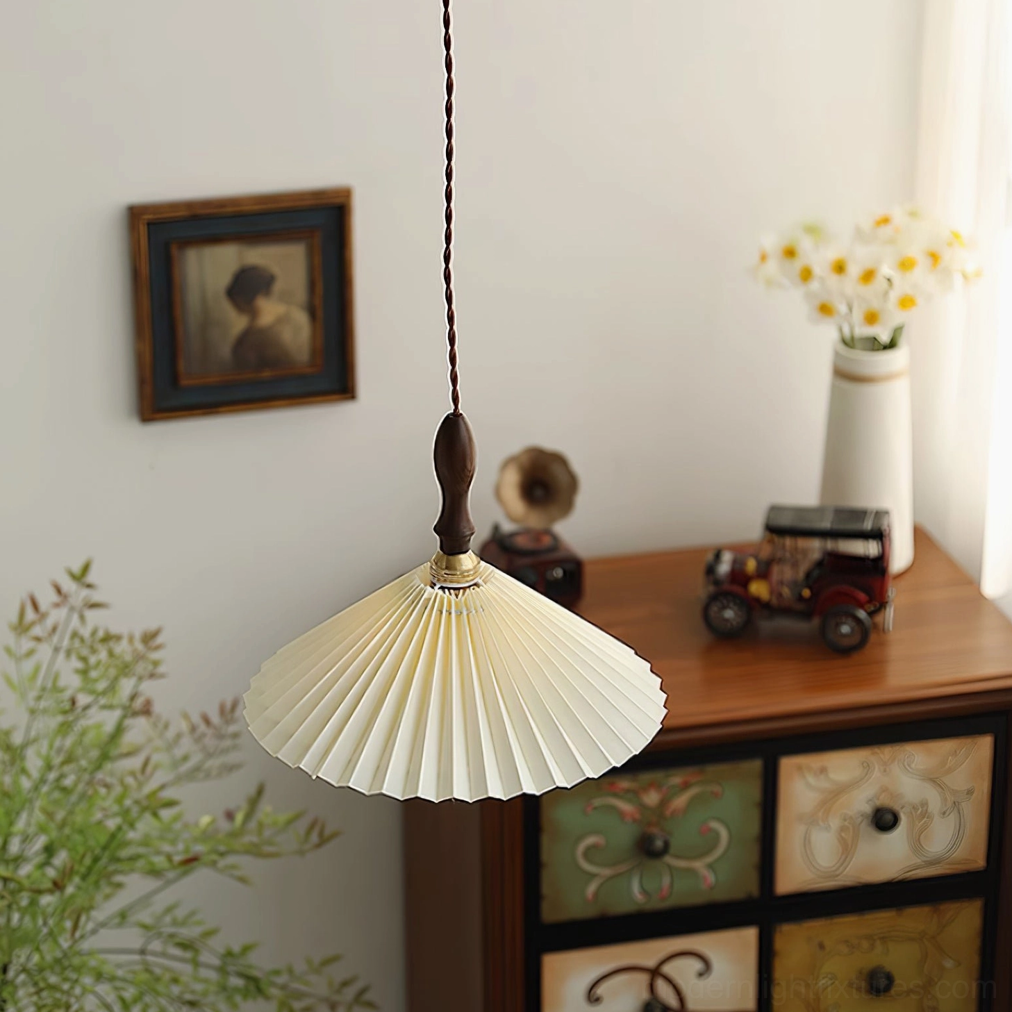 Geometric pleated pendant light above desk in home office workspace creating focused lighting