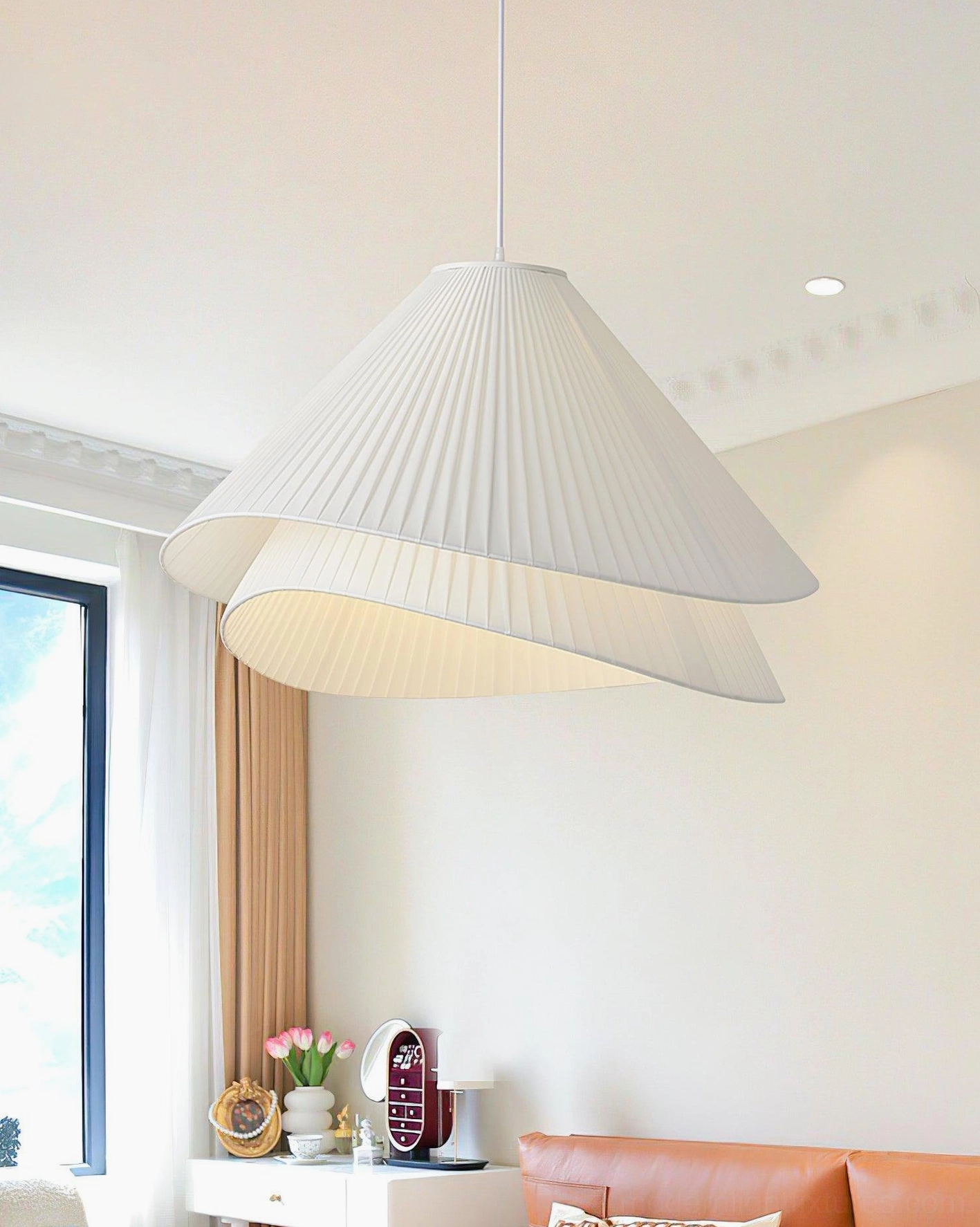 Pleated fabric pendant light in Nordic living room with orange sofa, warm beige color tone