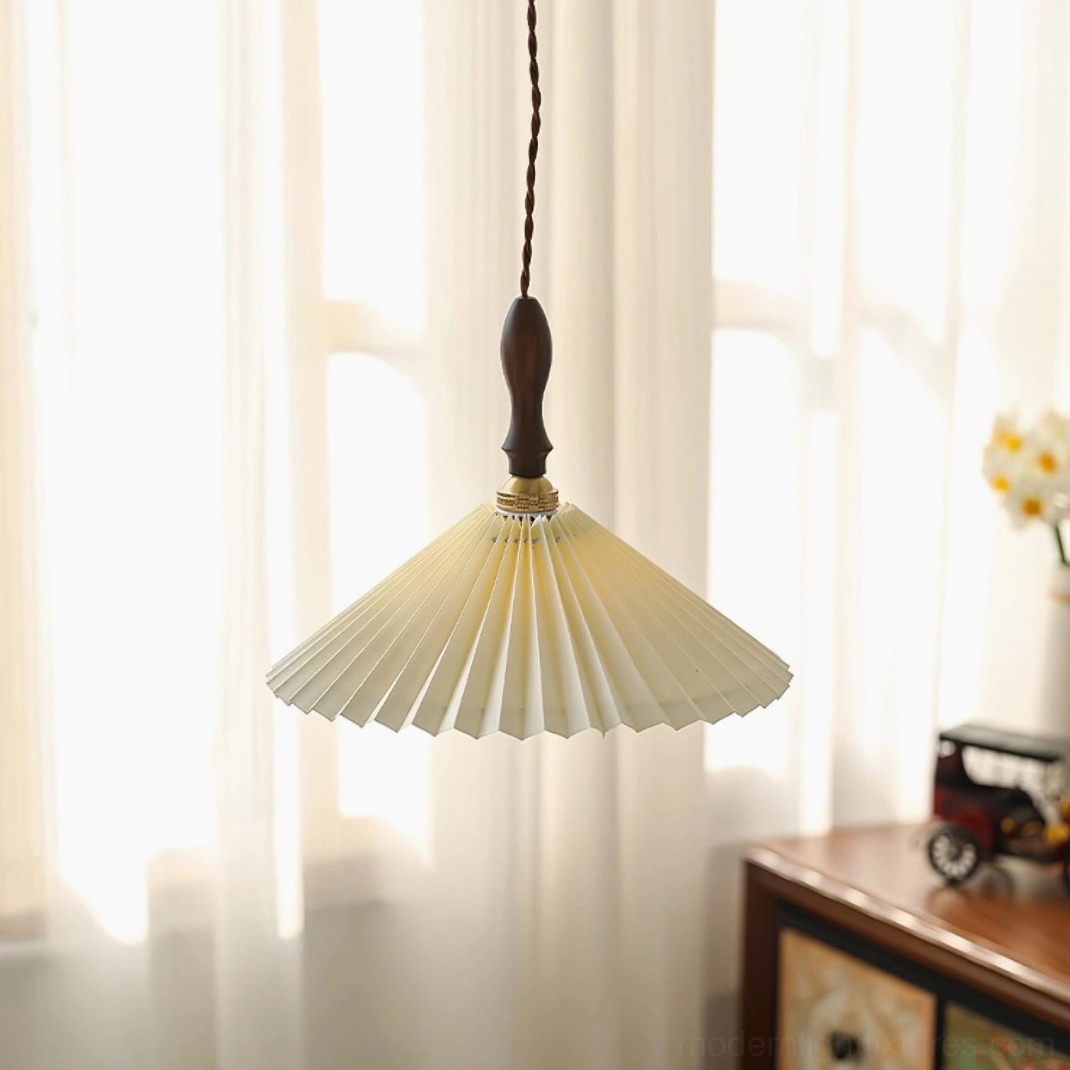 Side view of pleated fabric pendant light showing texture detail with walnut wood hanging fixture