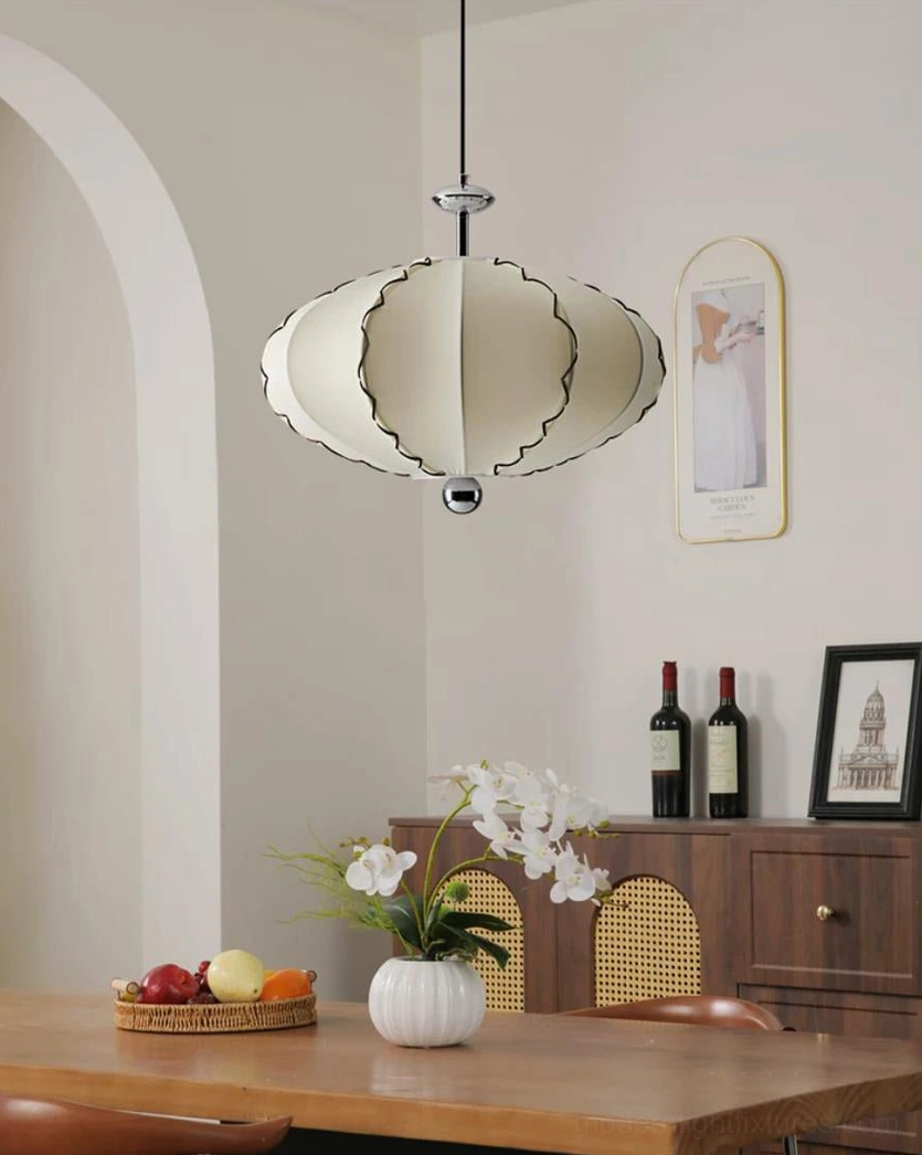 Full silhouette of cream pleated fabric pendant light showing oval sculptural shape and eight-panel construction from side angle