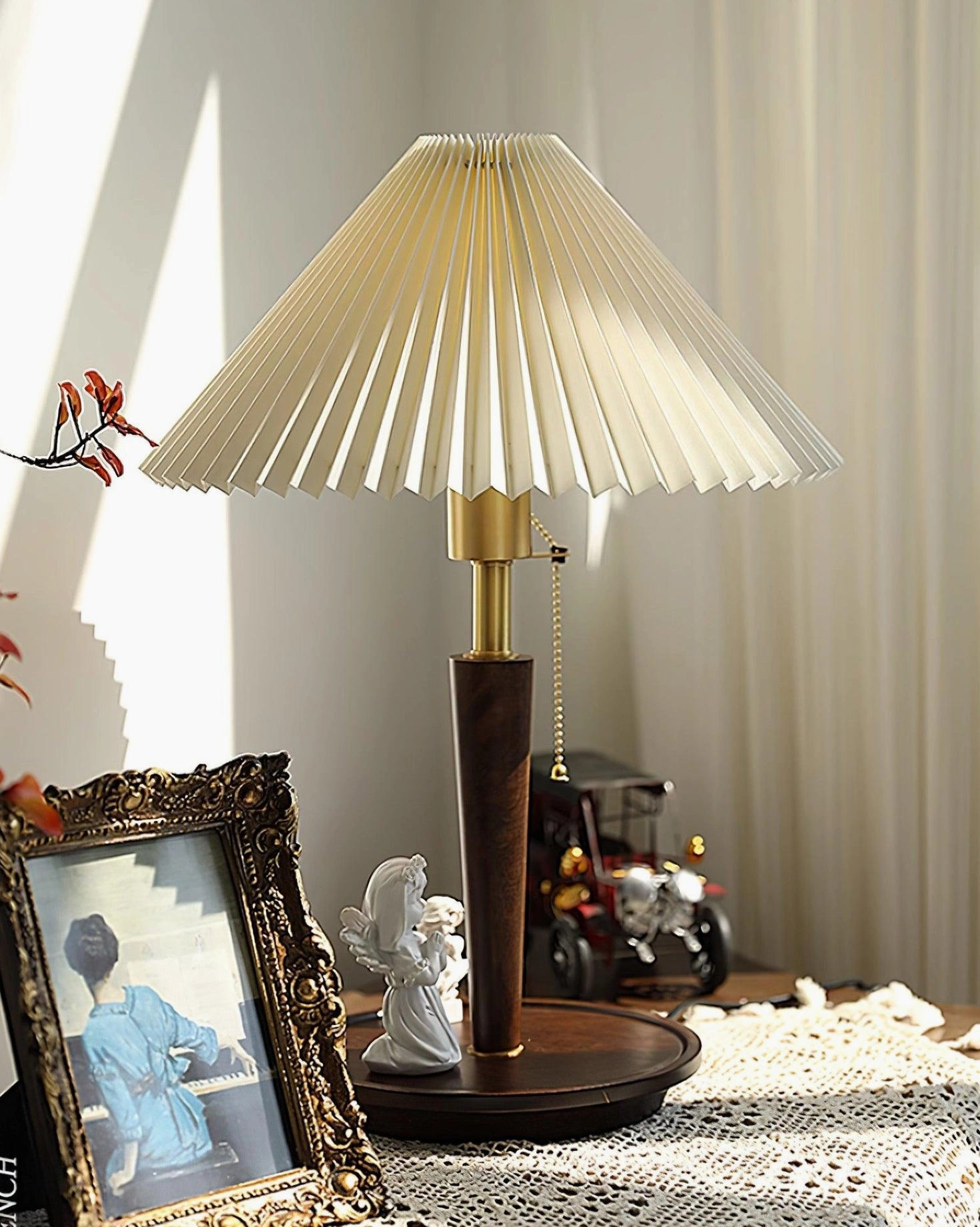 Suki pleated table lamp with brass accents and beige fabric shade, detailed back view showing cord and base construction