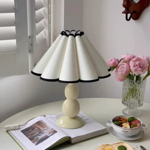 Vintage pleated table lamp styled on breakfast table with flowers and tableware in cottage aesthetic