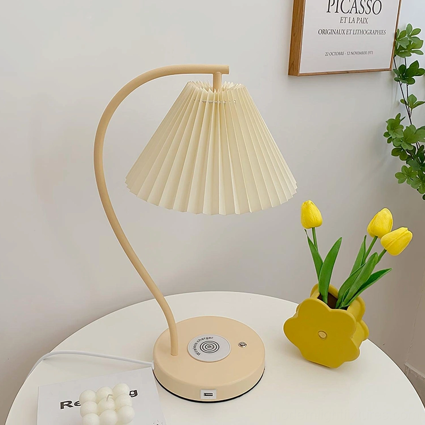 Pleated table lamp with cream shade on white round side table, modern design