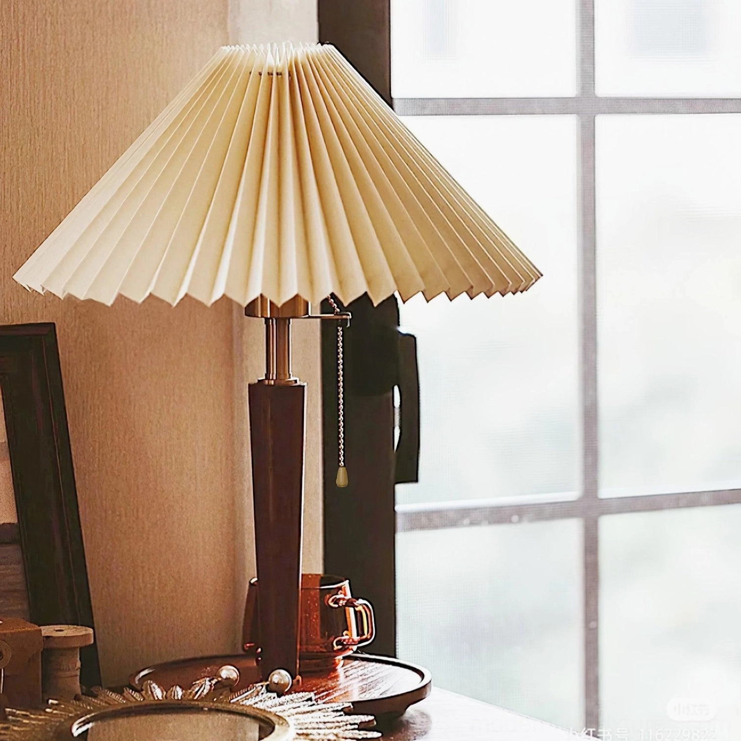 Contemporary pleated table lamp with push-button switch and dimmer compatibility on reading nook side table
