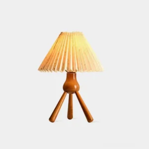 Mid-century pleated tripod table lamp with beige fabric shade and natural wood base, studio front view
