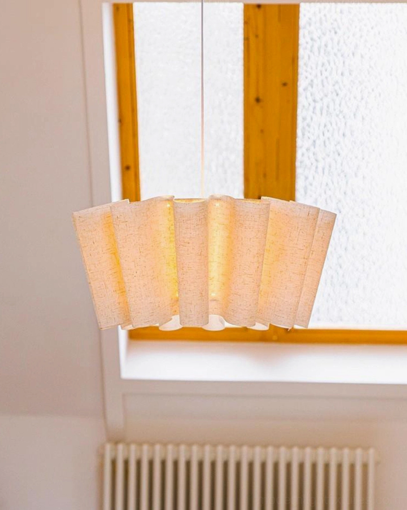 Pleora fabric pendant light with diffuser creating even warm illumination overhead