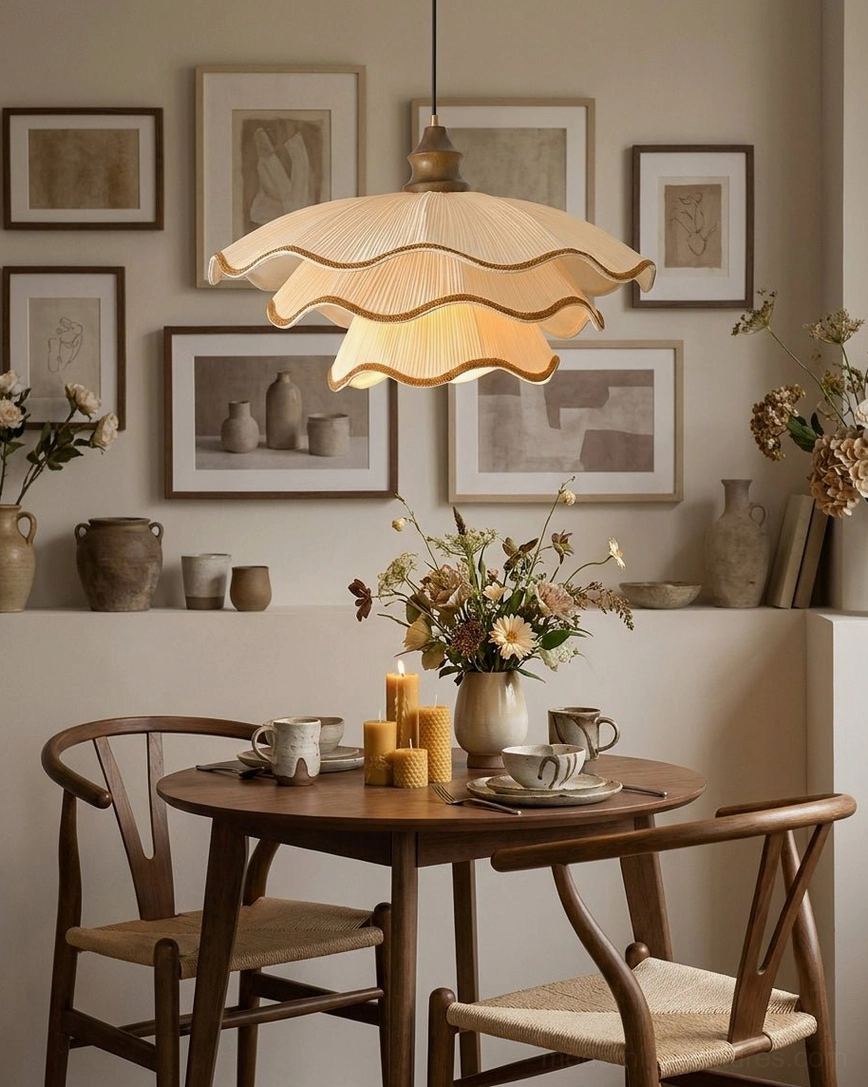 Pliora pendant light showing layered pleated shade construction with contrast piped scalloped edges in warm cream tone