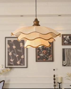 Pliora scalloped pendant light hanging in cozy dining nook with gallery wall and floral art, warm neutral aesthetic
