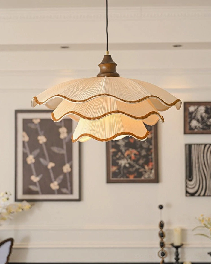 Pliora scalloped pendant light hanging in cozy dining nook with gallery wall and floral art, warm neutral aesthetic