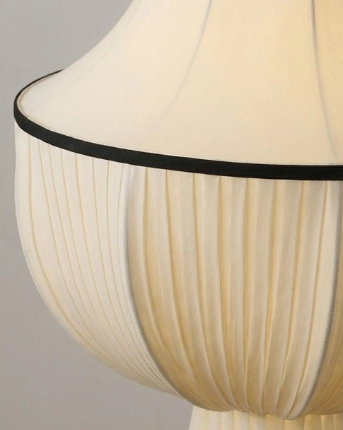 Plisselle pleated fabric pendant light close-up macro detail shot, cream pleated texture with black top trim, studio lighting reveals fabric pleats